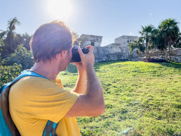 istock Young man photographing ancient temple in Mexico 1367191988