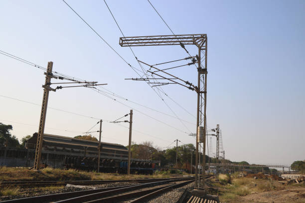 istock Railway electrification system. Power line wire over rail track. High metal construction transporting voltage energy. 1367194207