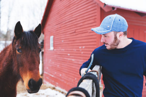 Man standing next to horse