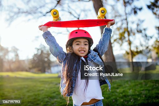 istock Girl With Red Skateboard and Helmet 1367197193