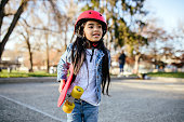 istock Girl With Red Skateboard and Helmet 1367197312