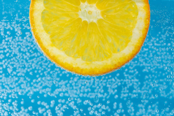 istock Orange fruit slices under water vegan and vegetarian concept. 1367199073