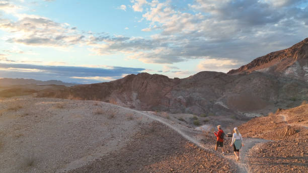 istock Hiking couple following trail through desert 1367199993