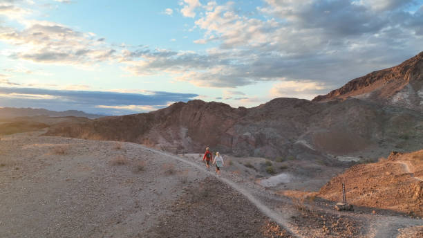 istock Hiking couple following trail through desert 1367200005