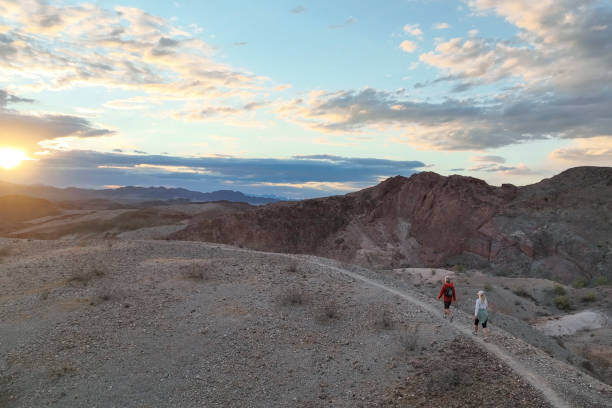 istock Hiking couple following trail through desert 1367200024