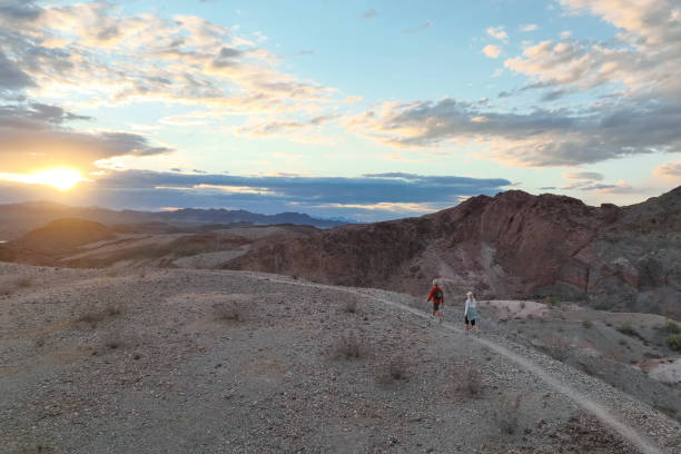 istock Hiking couple following trail through desert 1367200036