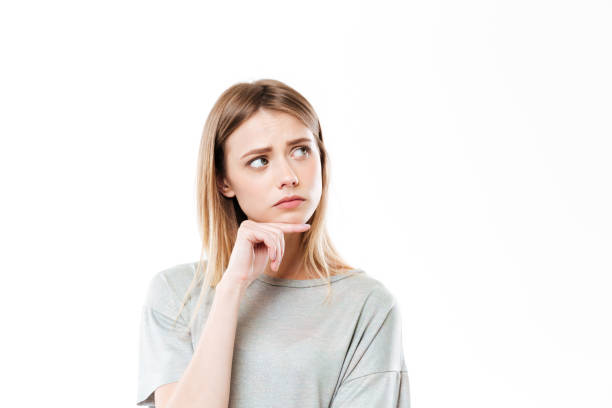 istock Sad thinking young woman standing isolated 1367200396