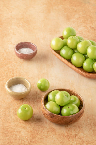 istock fresh ripe green plum fruits and salt on table 1367201412