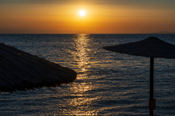 Orange and yellow sunset on the sea. Aerial panoramic view of sunset over sea.