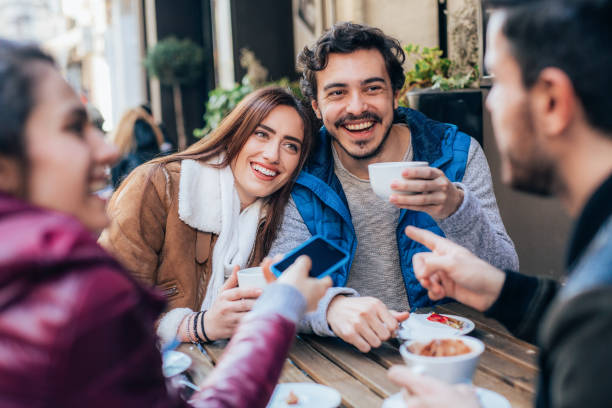 istock Friends talking and laughing in a cafe 1367203535
