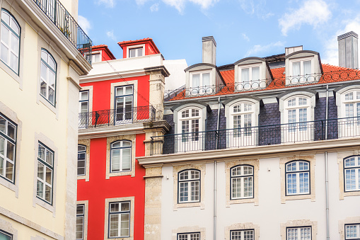 Exterior walls, balconies and rooftops of large apartment buildings in central Lisbon, Portugal.