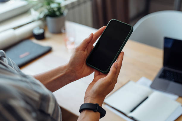 istock Anonymous Young Businesswoman Holding a Smartphone 1367206884