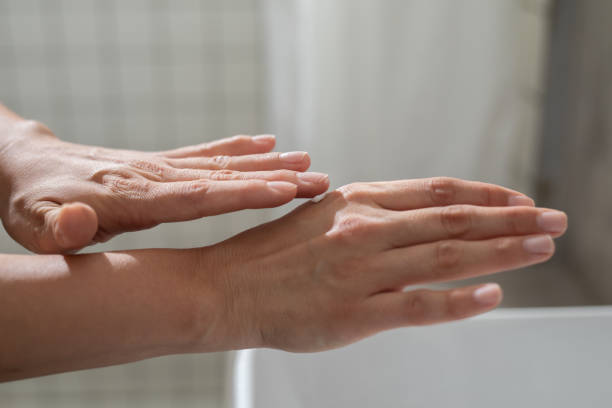 istock Anonymous Young Woman Applying a Hand Cream 1367206924