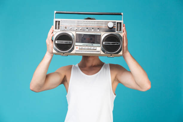 istock Man covering face with tape recorder. 1367207962