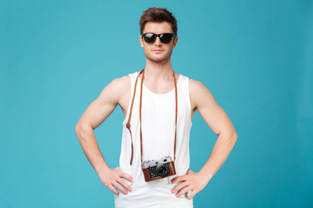istock Man in sunglasses posing isolated over blue background 1367207998