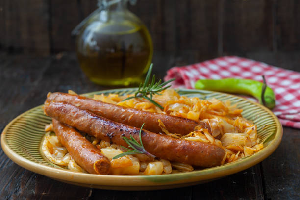 Traditional cooked sauerkraut with sausages and beer. stock photo