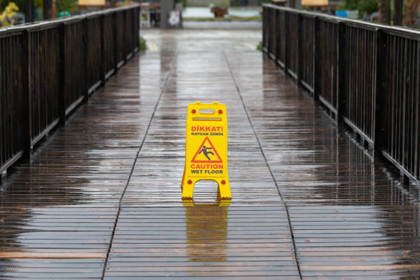 Yellow caution wet floor sign on parquet floor. No people.