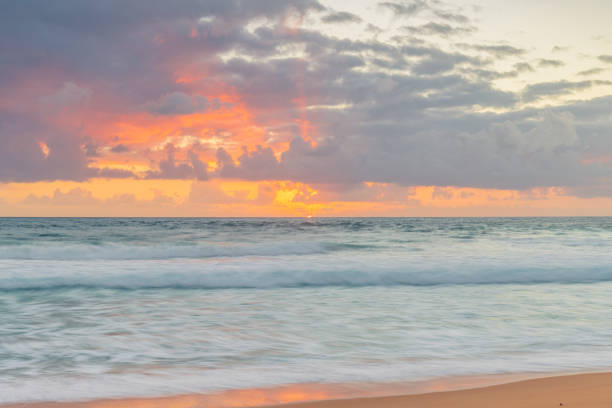 istock Sunrise at the seaside with waves and clouds 1367212078