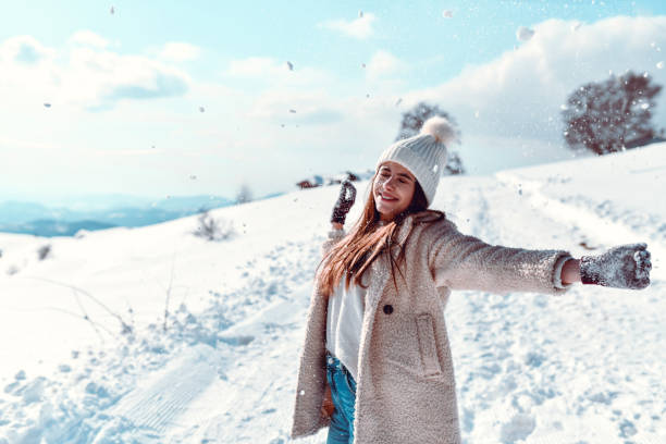 istock Cute Female Throwing Snow All Around On Mountain 1367212423