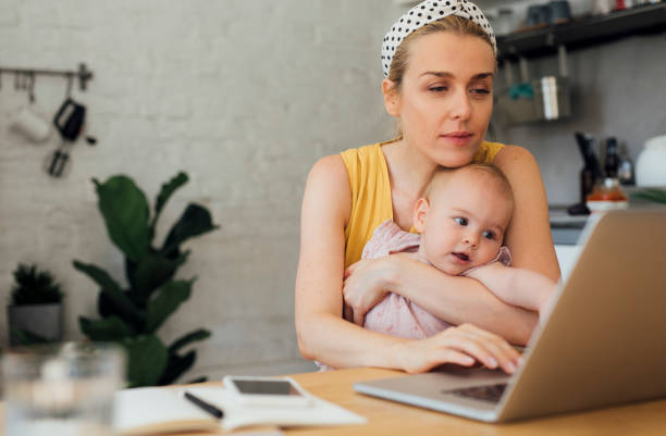 istock Portrait of a Working Mom and Her Baby While Using a Laptop at Home 1367213874