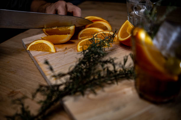 cutting oranges for vermouth on top of a wood cutting oranges for vermouth on top of a wood vermouth stock pictures, royalty-free photos & images