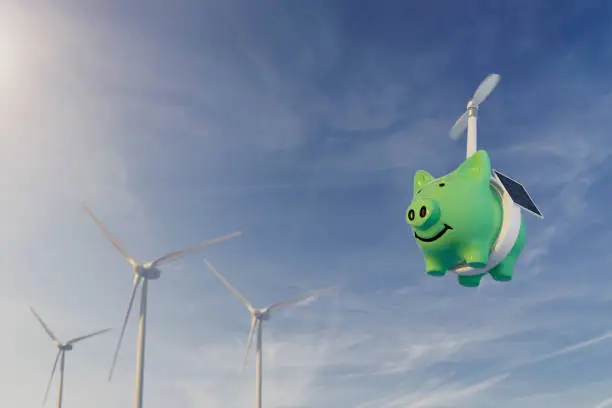 Sustainable Investment Concept - 3D piggy bank flying with aerial drone powered by solar panel near wind turbine / wind farm.

*Note to inspector**  These images were created January 2022 for Landesbank Brief