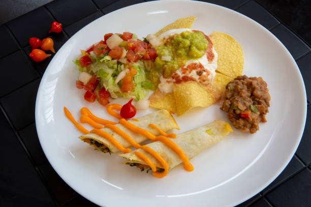 dish of typical mexican food, on a black towel - guacamole food bar vegan food imagens e fotografias de stock