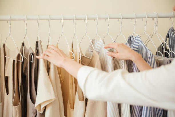 istock Close up of clothes hanging on rack 1367217514