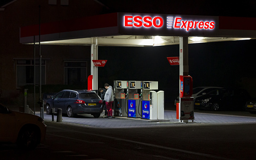 Wierden, Twente, Overijssel, Netherlands, january 26th 2022, two men refueling their Dutch 2017 Peugeot 308 station wagon with diesel fuel at a small local 