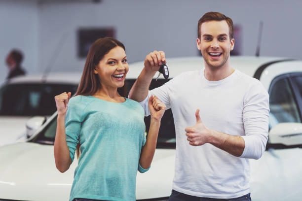 istock Couple buying a car 1367218876