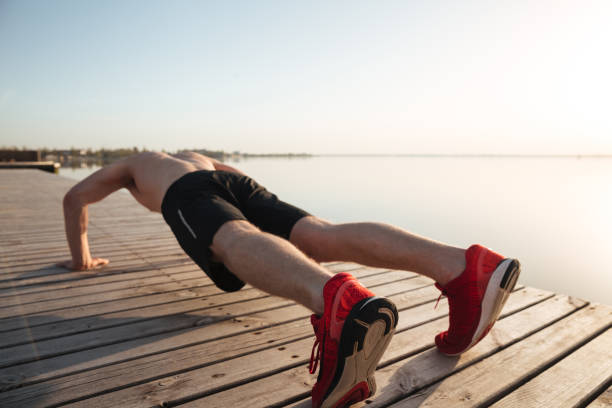 istock Portrait of a healthy young man doing push ups 1367218958