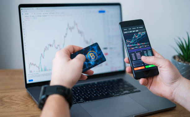 istock Businessman buying cryptocurrency through mobile phone app. 1367219751