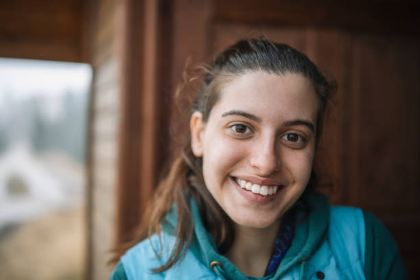 Close up portrait of smiling woman on a mountain vacation.