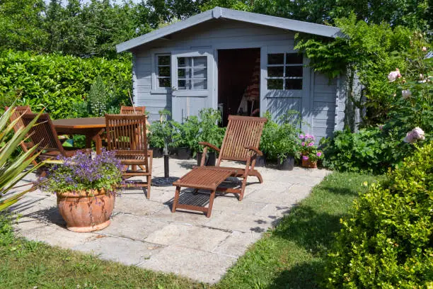 Shed with terrace and garden furniture in a garden