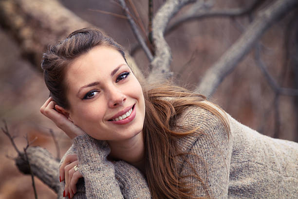 istock Beautiful girl smiling while laying on tree 136722115