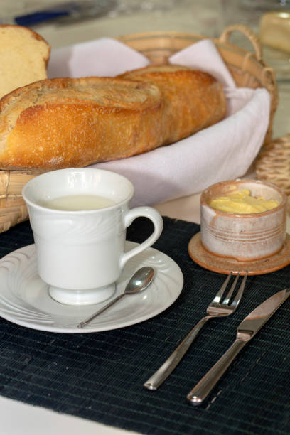 istock Breakfast table with bread, butter and cup of milk 1367221218