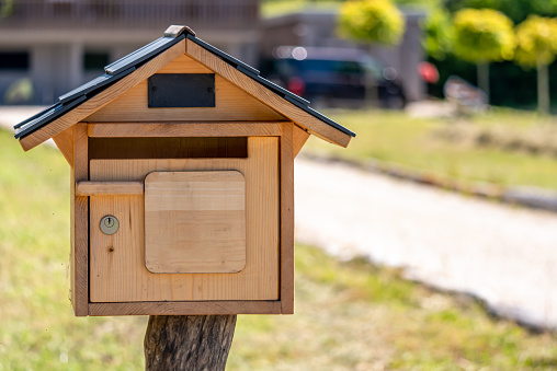 Wooden mail box with lock in garden. Outdoor.
