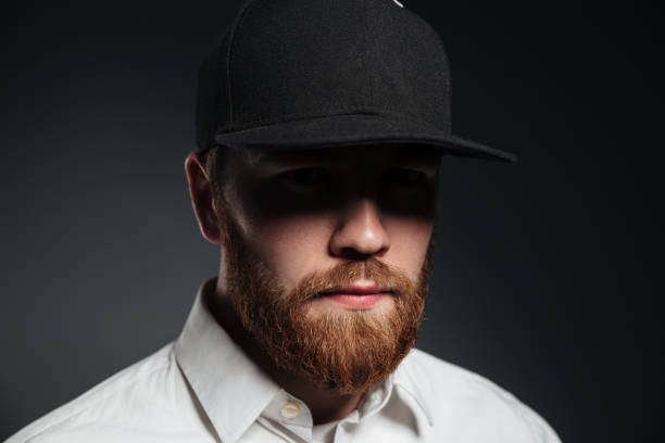 istock Handsome serious bearded young man wearing cap 1367223056