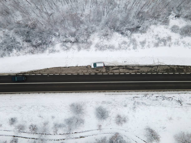 istock High angle top down aerial view drone image on road trough the trees and forest in mountain range covered with white snow in winter day near Knjazevac in Serbia car Travel journey and vacation concept 1367226670
