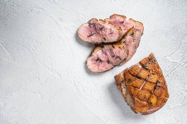 istock Roasted Sliced Duck breast fiilet steak. White background. Top view. Copy space 1367228271