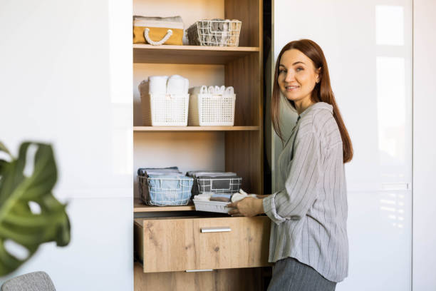 istock Smiling female putting clothes wardrobe comfortable vertical storage system Marie Kondo method 1367229094