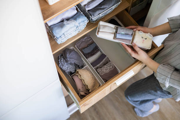istock Top view female hands comfortable boxes storage for panties, socks, bras Konmari method storage 1367229957