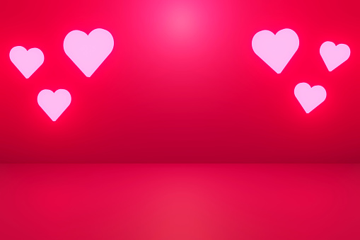 Background for Valentine’s day. Hearts with copy space on the illuminated color gradient red background
