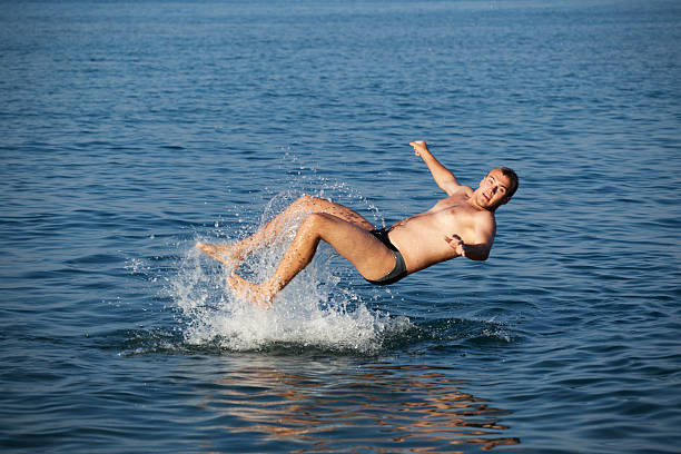 istock Young man jumping in water 136723287