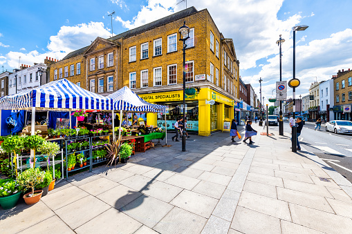 London, UK - June 21, 2018: Neighborhood of Pimlico in Victoria with Tachbrook street food farmers market in downtown with stall stand vendors and sign for Digital Specialists