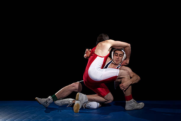 Wrestling Wrestling action. Studio shot over black. wrestling sport stock pictures, royalty-free photos & images