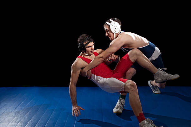 Wrestling Wrestling action. Studio shot over black. wrestling sport stock pictures, royalty-free photos & images