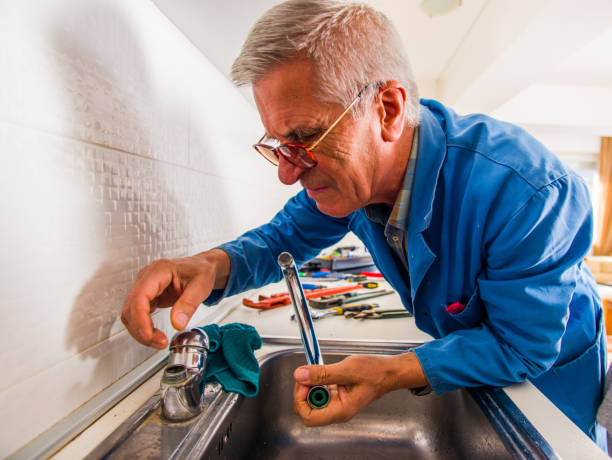 istock Mature handyman working in the kitchen 1367236359
