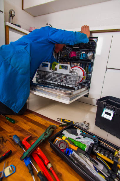istock Senior plumber fixing the dishwasher machine in kitchen 1367236455