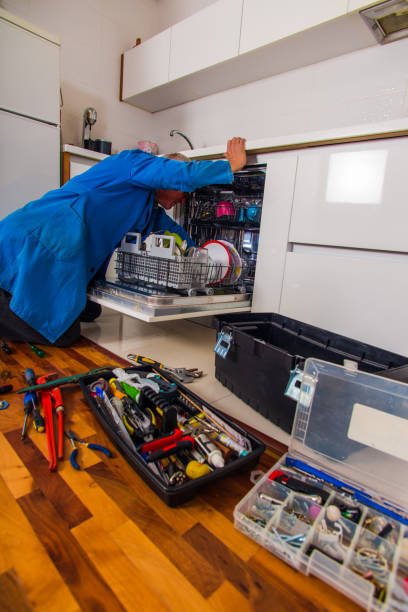 istock Handyman opening the dishwasher in white kitchen 1367236534